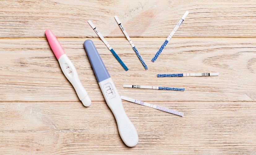 colored-pregnancy-test-on-wooden-background