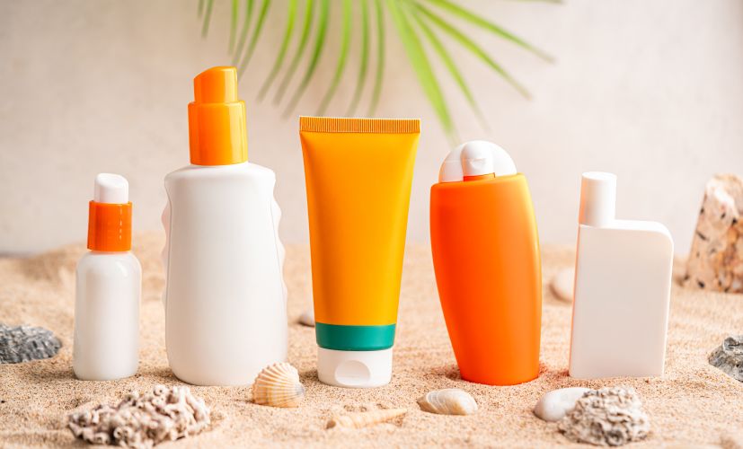 sunscreen-products-and-shells-on-beach-sand